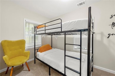 Bedroom with carpet floors and baseboards