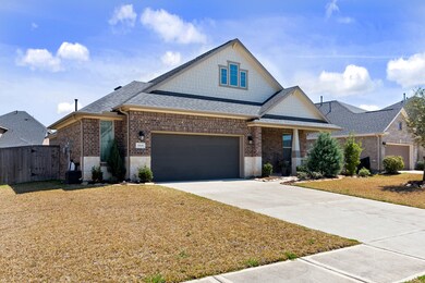 Lovely exterior features brick, stone & wood. Oversized 2.5 car garage for extra storage or a workshop area & window overlooking the double-wide driveway.