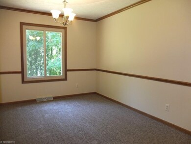 Formal dining room with crown molding and chair ra