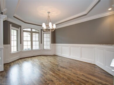 Formal dining area with adequate wall space for a sideboard or buffet.