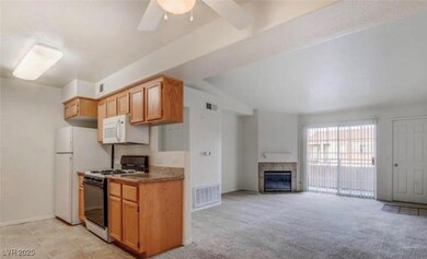 Kitchen with white appliances, a fireplace, a ceil