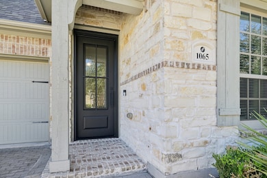 Entrance to property featuring stone and iron door