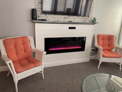 Sitting room featuring carpet and wood walls
