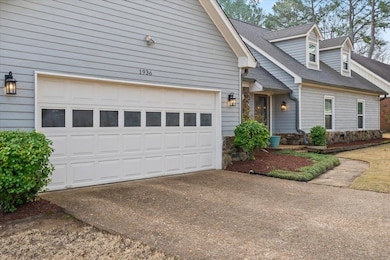 View of front facade featuring a shingled roof, a 