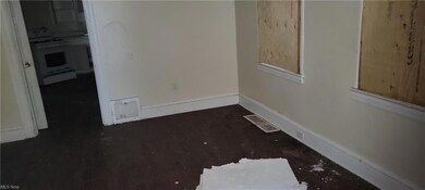 Unfurnished room featuring dark hardwood flooring