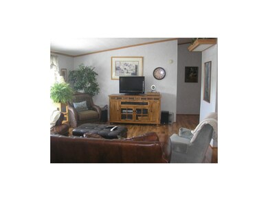 Spacious Living Room with bright windows and wood 
