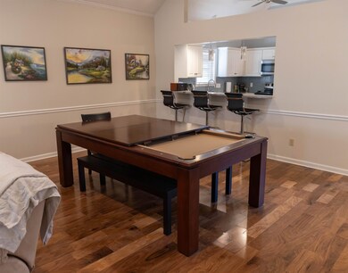 Living room featuring a ceiling fan, baseboards, d
