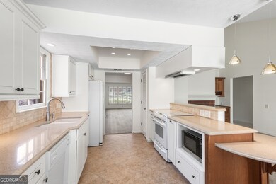 Kitchen with a peninsula, open to den with masonry