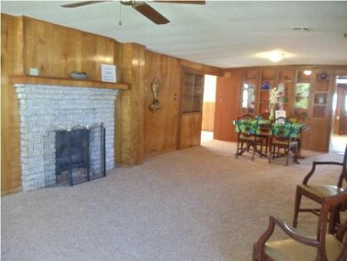 Large living room with new carpet, gas fireplace,