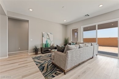 Living area featuring light wood-type flooring, recessed lighting, and baseboards
