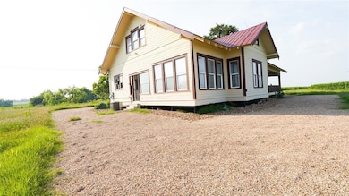 View of side of home with a metal roof