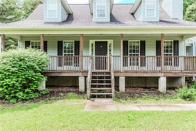 View of front of property with covered porch, roof