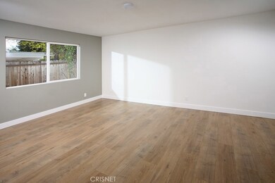 The expansive master suite is drenched in natural light and is further highlighted by a two-toned designer paint scheme, spacious walk-in closet and striking new wood laminate floors.