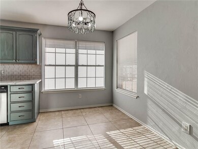 Brightly lit dining area open to kitchen and livin