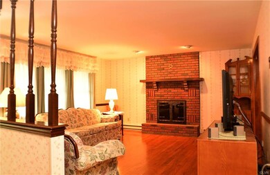 Living room with brick floor-to-ceiling fireplace 