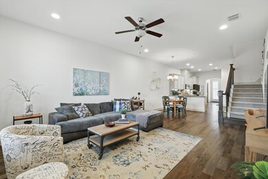 Living room featuring stairs, ceiling fan with not