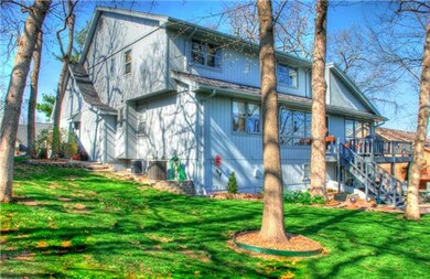 Back of home with view of deck.