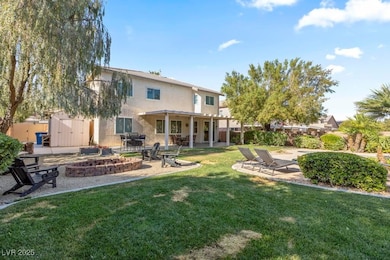 Rear view of house with an outdoor fire pit, a pat