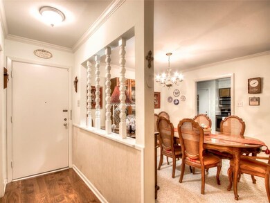 Entry with wood floors looking into the dining roo