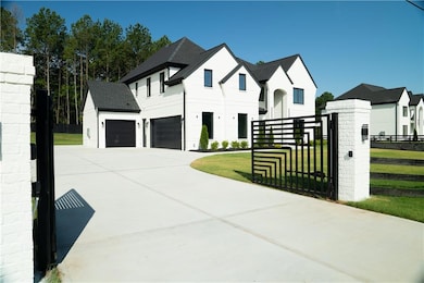 View of front of property featuring concrete driveway and a garage