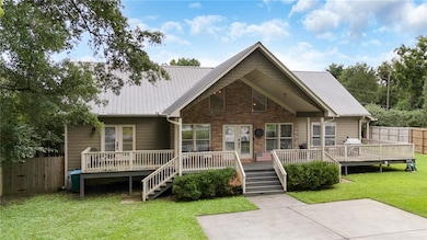 View of front of property with a wooden deck and a