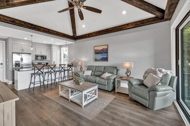Living room with a ceiling fan, dark wood-style fl
