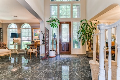 High ceilings in entry. arched windows, blinds and
