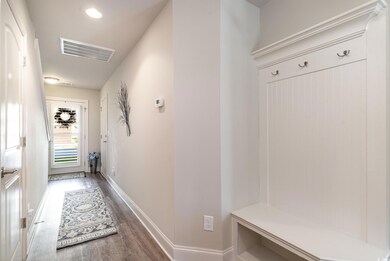 Mudroom with wood-type flooring