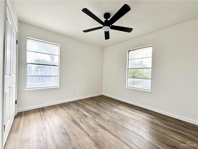 Empty room with hardwood / wood-style flooring and ceiling fan