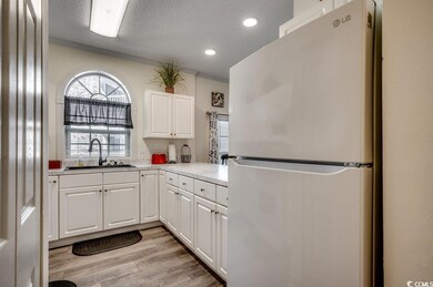 Kitchen featuring a textured ceiling, sink, white 