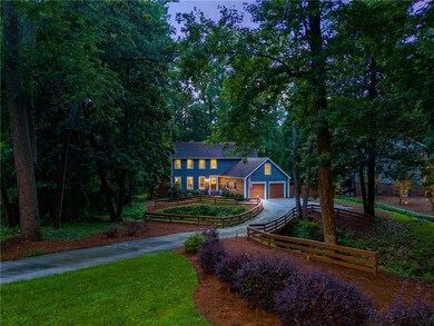 View of front of house featuring asphalt driveway and a garage