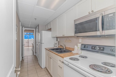 Kitchen featuring light tile patterned flooring, s