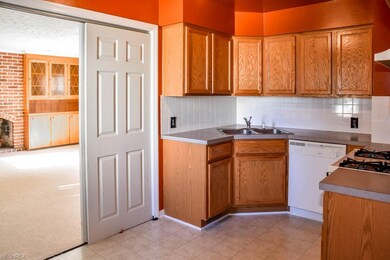 The kitchen has sliding doors to the family room.