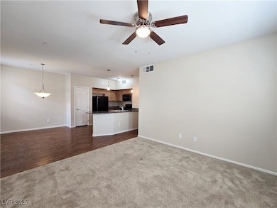 Unfurnished living room featuring dark colored car