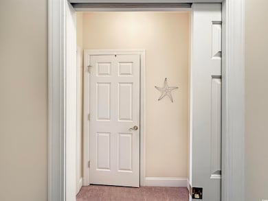 Hallway with light colored carpet