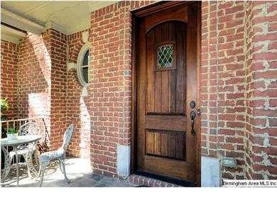 Brick home and front porch welcome all who visit.
