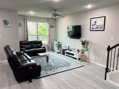 Living room featuring ceiling fan and light hardwood / wood-style flooring