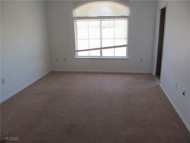 Empty room featuring baseboards and light carpet