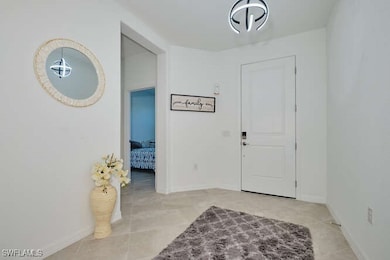 Foyer entrance featuring light tile patterned floo