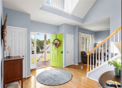 Entrance foyer featuring stairway and light wood-style flooring