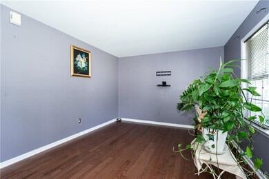Spare room featuring wood finished floors and base