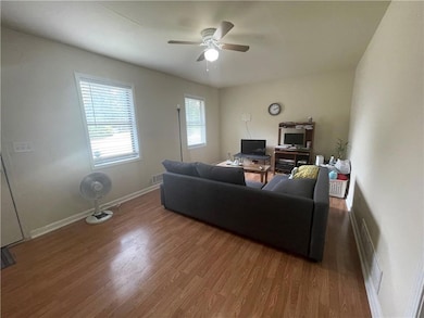 Living room with hardwood / wood-style floors and 