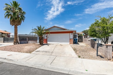 Single story home with brick siding, a garage, dri