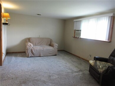 Living room has newer carpet and a large picture w