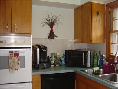 Kitchen with built-ins, ample wood cabinetry, stai