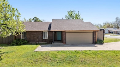 Ranch-style home with a garage, brick siding, fenc