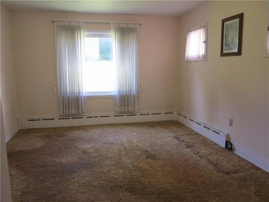 Large dining room with hardwood floors under carpe