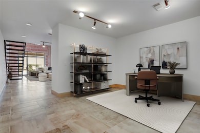 Just beyond the kitchen sits a spacious open room offering endless flexibility it can easily be transformed into a guest bedroom, home office, or personalized retreat to fit your lifestyle. This photo is virtually staged.