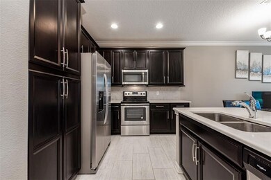 The family chef will fall in love with the kitchen offering upgraded STAINLESS STEEL APPLIANCES, CUSTOM TILE BACKSPLASH, GRANITE COUNTERS, 42” CABINETS with CROWN MOLDING and a CENTER ISLAND for even more storage and prep space, plus a BREAKFAST BAR for casual dining!