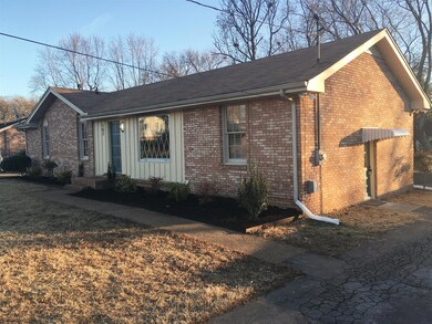 Wider view of home with covered side door to den. Newer roof, newer HVAC, all new light fixtures inside and out. 